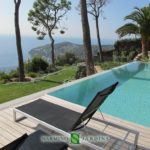 A splendid view of Cap Ferrat next to a swimming pool in a villa